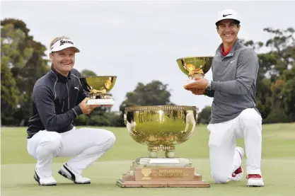  ?? — AP ?? MELBOURNE: Denmark’s Soren Kjeldsen, left, and partner Thorbjorn Olesen hold miniature replica’s of their trophy after winning the World Cup of Golf at Kingston Heath in Melbourne, Australia, yesterday.