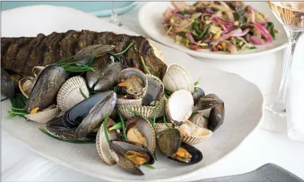  ??  ?? Pulling mussels from a shell: shellfish served at Fifteen Cornwall by head chef Adam Banks, who joined the restaurant in May