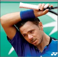  ?? AP/MICHAEL EULER ?? wipes his head as he plays Guillermo Garcia-Lopez during their first round match of the French Open on Monday at the Roland Garros stadium in Paris. Wawrinka, a former French Open champion, lost 6-2, 3-6, 4-6, 7-6 (5), 6-3.