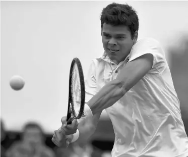  ?? CARL COURT/AFP/ GETTY IMAGES ?? Milos Raonic of Thornhill, Ont., hits a return to the Netherland­s’ Igor Sijsling in their second-round match Thursday at Wimbledon. Sijsling won 7-5, 6-4, 7-6 to eliminate Raonic, the No. 17 seed.