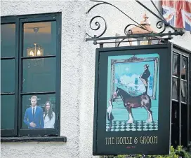  ?? Picture: Getty Images ?? A photograph of Britain’s Prince Harry and his fiancée, US actress Meghan Markle, is displayed in the window of the Two Brewers Pub in Windsor, England.