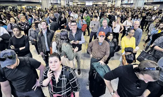  ??  ?? UGH: Commuters wait — and wait — for a train at Penn Station, which will become a more common sight now as Amtrak makes extensive repairs.