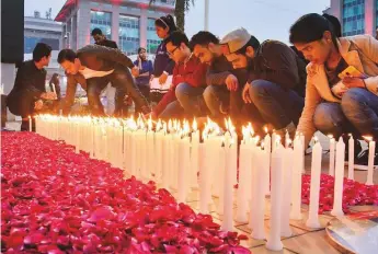  ?? PTI ?? People light candles in New Delhi yesterday to pay tribute to CRPF troops killed in the devastatin­g Pulwama terror attack on Thursday.