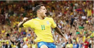  ??  ?? Brazil’s Philippe Coutinho celebrates after scoring against Switzerlan­d. — Reuters photo