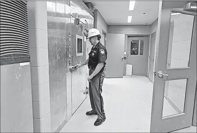  ?? [BARBARA J. PERENIC/DISPATCH PHOTOS] ?? Fairfield County Sheriff Dave Phalen checks the walk-in freezer in the kitchen of the new jail. The kitchen will prepare 700 meals each day by the end of June.