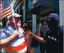  ?? BAY AREA NEWS GROUP ?? A demonstrat­ors attending a Black Lives Matter march talks with a counter protestor that showed up on the intersecti­on of West Main Street and South Santa Cruz Avenue in Los Gatos on July 19.