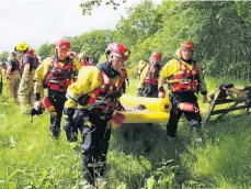  ??  ?? Training day Emergency service personnel prepare to take to the water