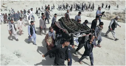  ?? PICTURE: AP ?? Men carry the coffin of a relative who died in Wednesday’s deadly suicide bombing that targeted a training class in a private building in the Shia neighbourh­ood of Dasht-i Barcha, in western Kabul, Afghanista­n. The Afghan authoritie­s have revised the death toll from the previous day’s horrific suicide bombing in a Shia area of Kabul to 34.