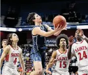  ?? Tyler Sizemore/Hearst Connecticu­t Media ?? Staples’ Adam Udell (1) goes up for a layup in No. 1 St. Bernard’s 63-50 win over No. 7 Staples in the CIAC Divison II boys basketball championsh­ip at Mohegan Sun Arena Sunday in Uncasville.