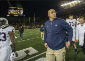  ?? TONY DING — THE ASSOCIATED PRESS ?? Penn State head coach James Franklin, center, walks off the Michigan Stadium field after an NCAA college football game against Michigan in Ann Arbor, Mich., Saturday.