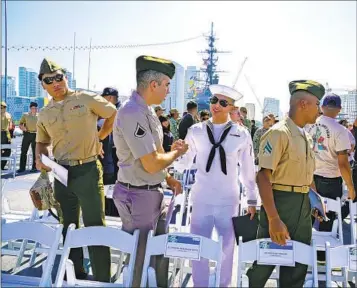  ?? NELVIN C. CEPEDA U-T ?? Mohamed El Yahyaoui from Morocco, serving in the Army National Guard, and David Jao from the Philippine­s, serving in the Navy, congratula­te each other at Friday’s U.S. citizenshi­p ceremony on the USS Midway.