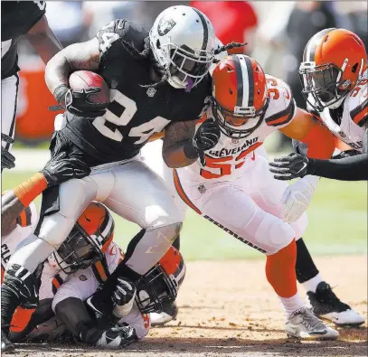  ?? Ben Margot ?? The Associated Press Raiders running back Marshawn Lynch fights for yardage against several Browns defenders Sunday in Oakland, Calif. Lynch ran for 130 yards on 20 carries.