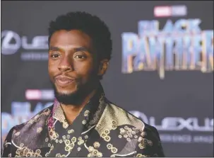  ?? The Associated Press ?? ISIXHOSA: Chadwick Boseman, a cast member in "Black Panther," stands at the premiere of the film at The Dolby Theatre on Jan. 29 in Los Angeles. The language of Wakanda in “Black Panther” is very much real, including the “click” sounds that are making...