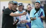  ?? ?? JOHN RAOUX — THE ASSOCIATED PRESS Fans takes selfie photos with Kevin Harvick, center, in the garage area during a practice session for the Daytona 500 at Daytona Internatio­nal Speedway on Feb. 17in Daytona Beach, Fla.