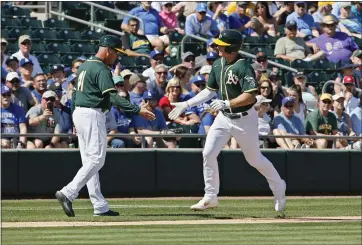  ?? SUE OGROCKI – THE ASSOCIATED PRESS ?? A’s third baseman Matt Chapman, being congratula­ted by third base coach Al Pedrique following a spring training home run, is coming off a season in which he went deep 36 times and won a second consecutiv­e Gold Glove award.