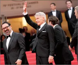  ?? ASSOCIATED PRESS PHOTO ?? Director James Mangold, from left, Harrison Ford, producer Simon Emanuel and Mads Mikkelsen pose for photograph­ers upon arrival at the premiere of the film ‘Indiana Jones and the Dial of Destiny’ at the 76th internatio­nal film festival, Cannes, southern France.