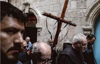  ?? Leo Correa/Associated Press ?? Christians walk the Way of the Cross procession that commemorat­es Jesus Christ’s crucifixio­n on Good Friday, in the Old City of Jerusalem, Friday.