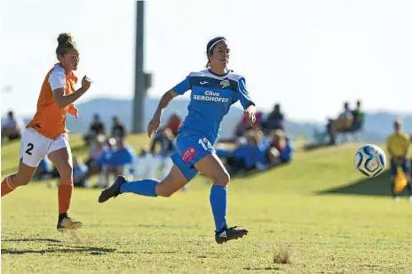  ?? Photos: Kevin Farmer ?? South West Queensland Thunder striker Louise Rolfe (right) breaks away from the Brisbane Roar defence. Rolfe scored in the Thunder’s 4-1 defeat to the Roar. BELOW RIGHT: Caitlyn Stocker sends the ball downfield.