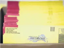  ?? RICK BOWMER/AP 2020 ?? While many support a voter identifica­tion law, Democrats are more worried about progress in voting rights for Black Americans. Above, mail-in ballots in Utah.