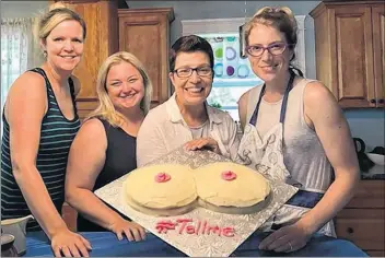  ?? SUBMITTED PHOTO/FACEBOOK ?? Kathy Kaufield, second from the right, displays a cake baked by volunteers involved with the #TellMe campaign. Kaufield, who lives in New Brunswick and is originally from Stratford, P.E.I., started the campaign to raise awareness about how mammograms can miss tumours from women with dense breasts.