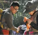  ??  ?? Zhou Deyao and his wife check on some bugs they’ve collected in Hainan province.