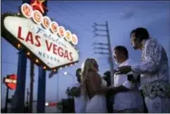  ?? JOHN LOCHER — THE ASSOCIATED PRESS ?? In this photo, Eddie Powers, right, performs as Elvis during a wedding for Wil and Sarah Wilson in Las Vegas. Powers works full-time as an Elvis tribute artist performing at weddings and leading Elvis themed tours around Las Vegas.