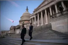  ?? Win McNamee/Getty Images ?? Sen. Ted Cruz, R-Texas, left, and special assistant Gray Harker depart the U.S. Capitol at dawn Wednesday after an overnight session of the Senate in Washington. The Senate voted on a series of amendments known as a “vote-a-rama” prior to final passage of a $3.5 trillion budget resolution.