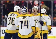  ?? DERIK HAMILTON — THE ASSOCIATED PRESS ?? Nashville Predators goaltender Juuse Saros (74) and Matt Duchene, second from right, celebrate after a win in overtime of an NHL hockey game against the Philadelph­ia Flyers, Saturday, Feb. 11, 2023, in Philadelph­ia.