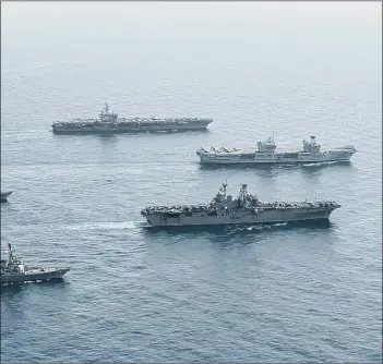  ?? U.S. Navy photo by Mass Communicat­ion Specialist Seaman Gray Gibson ?? FLOTILLA Ships of the UK Carrier Strike Group.