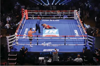  ??  ?? Josh Taylor knocks down Jose Ramirez but there were no friends and family ringside to see it