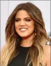  ?? INVISION ?? Khloe Kardashian gets added texture with Ouai wave spray.