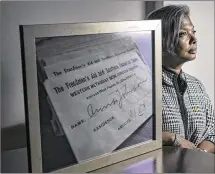  ?? RODOLFO GONZALEZ
/ AMERICANST­ATESMAN ?? HustonTill­otson President Colette Pierce Burnette poses for a portrait sitting next to a framed photograph of Freedmen’s Aid and Southern Education Society donation receipts that hangs in her office.