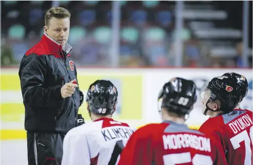  ?? JEFF MCINTOSH/ THE CANADIAN PRESS ?? Calgary Flames new head coach Glen Gulutzan gives instructio­n during an on-ice session at training camp in Calgary. Gulutzan spent three years as an assistant with the Vancouver Canucks before taking the Calgary job.