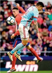  ?? AFP ?? Fernando Torres (back) of Atletico Madrid challenges Celtas Vigo’s Stanislav Lobotka during their Spanish league match on Sunday. Atletico won 3-0. —