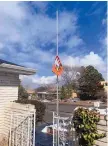  ?? PHOTO COURTESY OF SHAWN DICKMAN ?? An Eldorado High School flag flies at half-staff at the Dickman home in Northeast Albuquerqu­e. Brody Dickman is a kicker for the Eagles.