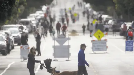  ?? Liz Hafalia / The Chronicle ?? Pedestrian­s take advantage of Lake Street, closed to vehicle traffic near Funston Avenue in San Francisco’s Richmond District.