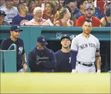  ?? Michael Dwyer / Associated Press ?? The Yankees’ Giancarlo Stanton, right, watches from the dugout during Sunday’s loss to the Red Sox in Boston.