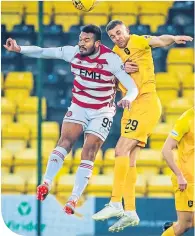  ??  ?? Aaron Taylor-Sinclair (right) challenges Marios Ogkmpoe of Hamilton Accies