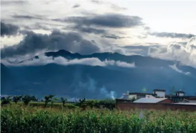  ??  ?? Enjoying sunset in a tiny town just a few kilometers from Dali. As the sun drops, all the clouds covering the mountains begin to dissipate. This mystical environmen­t is the result.