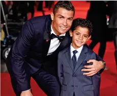  ??  ?? Proud father: With Cristiano Ronaldo Jr, seven