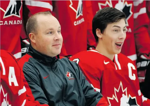  ?? JEFF MCINTOSH/ THE CANADIAN PRESS ?? Canadian junior team head coach Steve Spott, left, and Ryan Nugent-Hopkins share a laugh during a photo session Friday at Calgary.