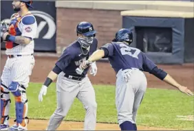  ?? Adam Hunger / Associated Press ?? Clint Frazier, second from left, of the Yankees is congratula­ted by teammate Giancarlo Stanton after Frazier’s two-run home run Saturday.