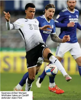  ??  ?? Swansea striker Morgan Whittaker takes on Cardiff defender Aden Flint