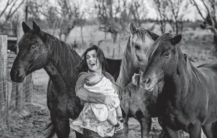  ?? Tori North / Contributo­r ?? Equine therapy has helped Christians­on, shown with son Daniel, cope with her physical and emotional wounds.