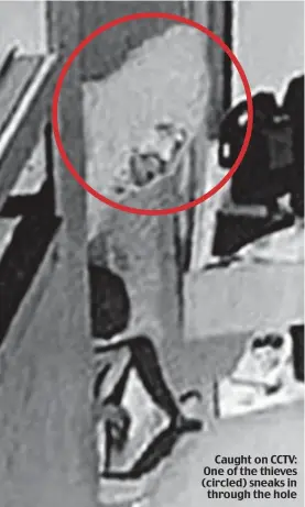  ??  ?? Caught on CCTV: One of the thieves (circled) sneaks in through the hole