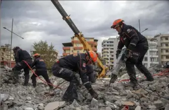  ?? Associated Press ?? Turkish rescuers search Thursday at a collapsed building in Durres, western Albania.