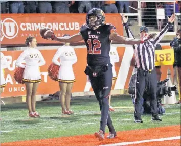  ?? Rick Bowmer Associated Press ?? USC’S CHEERLEADE­RS don’t have much to cheer as Utah’s Tim Patrick celebrates his 18-yard touchdown catch with 16 seconds to play. Patrick had six catches for 100 yards as the Utes stayed unbeaten.