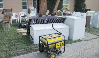  ?? DAX MELMER ?? Flood-soaked items sit outside one of the units at the Alix J. Sinkevitch townhouses after last week’s massive flooding in Windsor. Some residents are upset about pickers taking items such as wet and sewage-contaminat­ed mattresses for resale at garage...