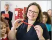  ?? THOMAS LOHNES — GETTY IMAGES ?? Andrea Nahles, leader of the German Social Democrats, holds a 3D print of the slogan “Digitale Bildung fuer Alle” (digital education for all) at the HABA Digitalwer­kstatt for child education in Germany.