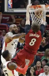  ?? ALAN DIAZ/THE ASSOCIATED PRESS ?? Heat guard Tyler Johnson dunks past Raptors forward P.J. Tucker in Saturday night’s game in Miami.